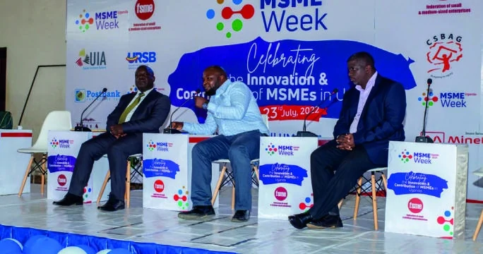 Three speakers take part in a discussion on the MSME Week stage.