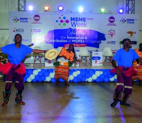 Performers in colourful costumes dance in front of the MSME Week stage.